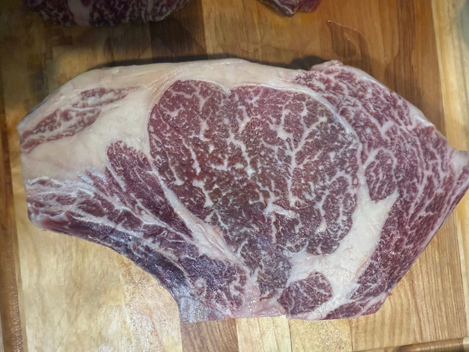 Marbled Belted Galloway ribeye on a wooden board